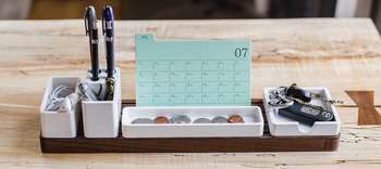 Bachelor Verwaltungswissenschaft Foto eines Schreibtischorganizers. In verschiedenen Fächern befinden sich Stifte, Schlüssel, Münzen und Karteikarten.