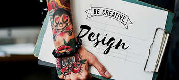Design Zu sehen ist ein Ausschnitt einer Person, welche ein Klemmbrett in der Habnd hält. Den Arm der Person zieren viele Tattoos und auf dem Klemmbrett befindet sich ein Zettel mit der Aufschrift: BE CREATIVE. DESIGN.